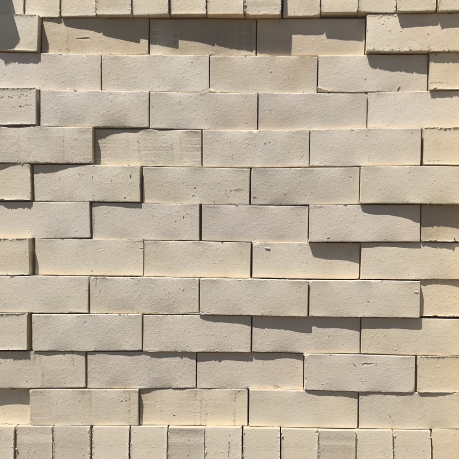 Agate Satin Face Brick featuring a creamy-ivory color tone and a smooth, low-sheen satin finish for modern masonry.