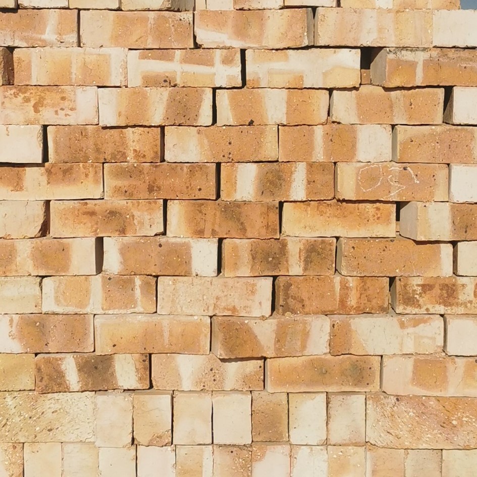 Krypton Satin SemiFace Bricks featuring a blend of pink and yellow tones with a smooth satin finish for decorative architectural walls.