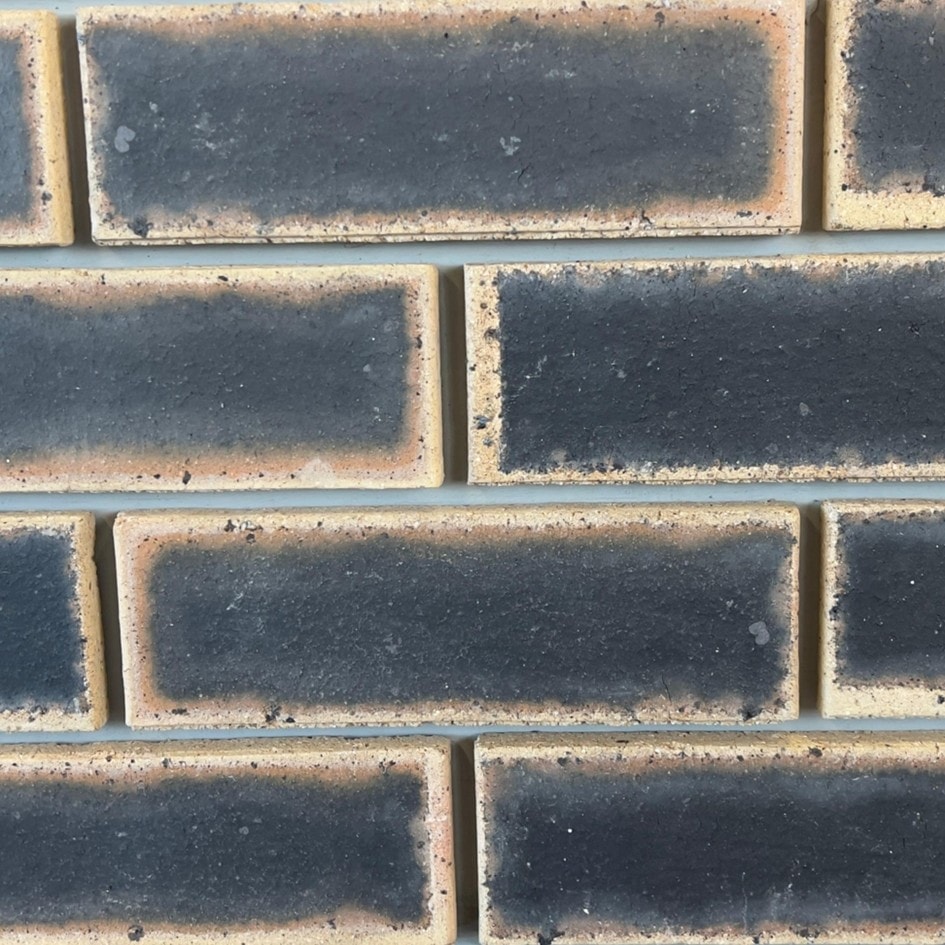Granite Satin Face Brick featuring deep black tones and a smooth satin finish for modern architectural facades.