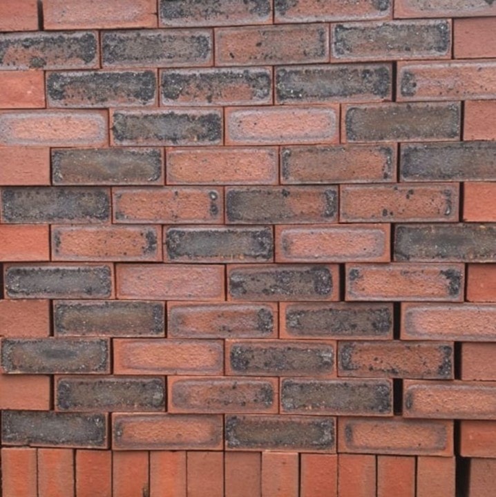 Rusty Blend Satin Dark Face Brick featuring striking red and blue tones with a smooth satin finish for modern building facades.