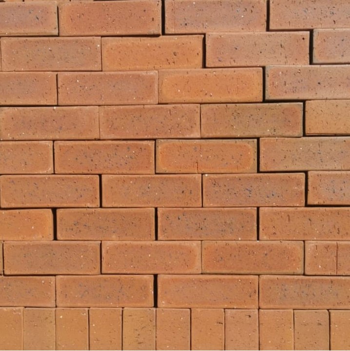 Village Antique Dark Travertine Face Brick featuring a deep rich red antique color profile and a textured surface.