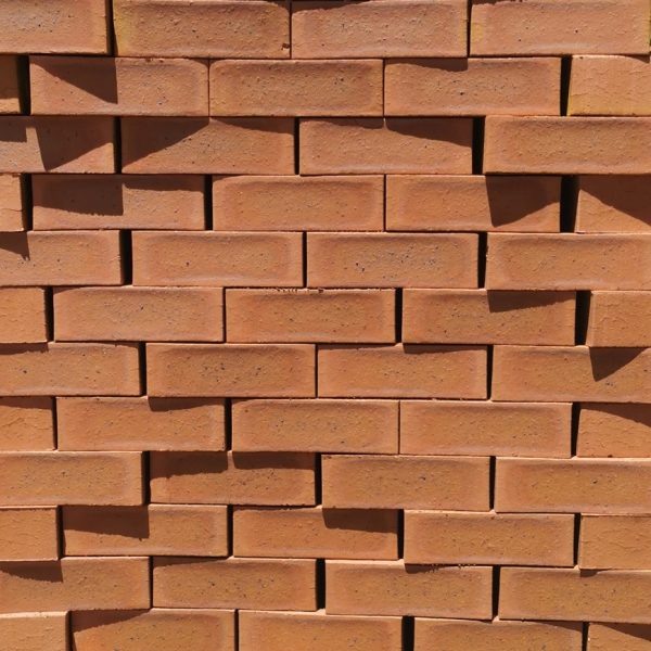 Amber Satin Face Brick featuring a pure red clay color profile with a slight burn and a smooth satin texture for residential and commercial building projects.