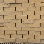 Buff Travertine Blend Face Brick featuring a vibrant yellow clay color profile and a deeply textured travertine finish for premium residential, commercial, and industrial construction.