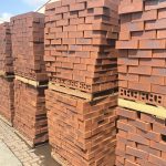 Country Classic Satin Face Brick featuring vibrant ruby red tones with a deep blue-burnt flash and a smooth satin texture for feature walls and premium construction.