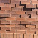 Festival Antique Satin Face Brick showcasing a red-toned clay profile with a dynamic mix of light ruby and dark red tones, featuring a smooth satin finish.