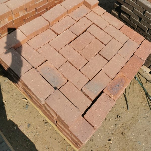IronStone Variation Straight Edge Paver featuring deep burgundy red tones with a unique blue-burnt flash and crisp, straight edges for a smooth, interlocking paved surface.