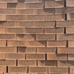 Moroccan Red Travertine Face Brick featuring a royal red color profile with blue spots and a rugged travertine texture for traditional and modern structural walls.