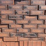 Rusty Blend Satin Dark Face Brick featuring a rich red base with a striking black and red-burnt face and a sleek, smooth satin finish for contemporary building facades.