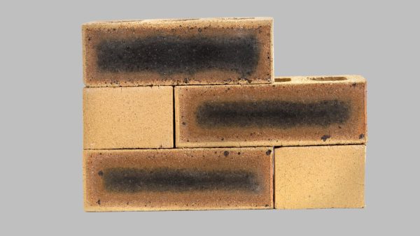 Stacked sample of Granite Satin Face Bricks, a premium, speckled light brown clay face brick with dark hearting and smooth texture, for sale in Gauteng.