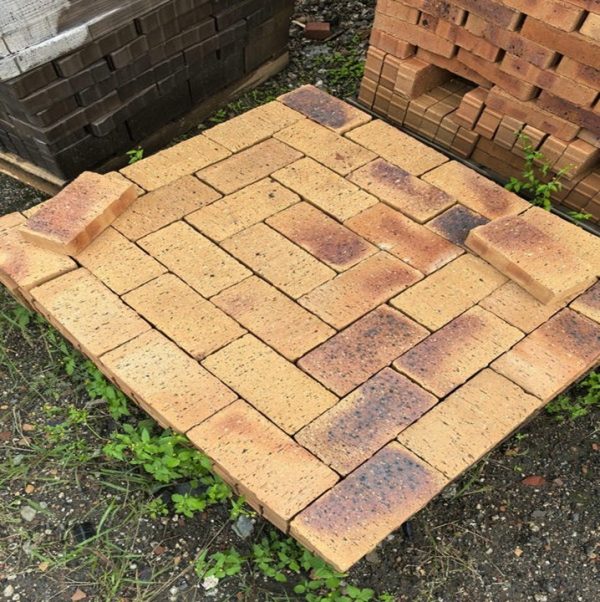 Namaqua Stone Variation Straight Edge Paver featuring vibrant orange clay tones with dark blue burns and a uniform profile for smooth driveways and walkways.