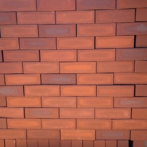 Redwood Satin Dark Face Brick featuring a dynamic mix of light ruby to dark red clay hues with a smooth satin finish for budget-friendly building projects.
